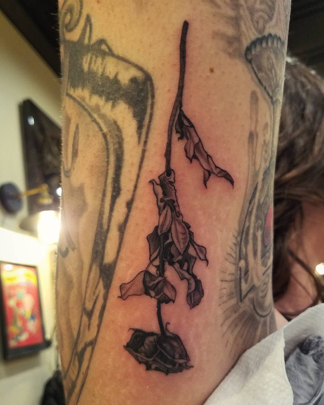 Expressive black dead flower tattoo on arm Tattoo on skin