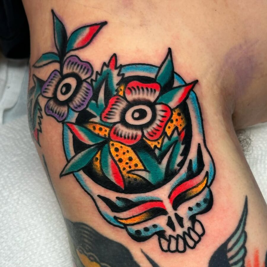 Vibrant dead flower skull tattoo with leaves Tattoo on skin