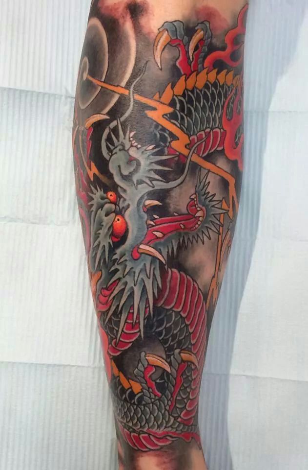Black and Orange Wise Japanese Dragon Tatto Tattoo on skin