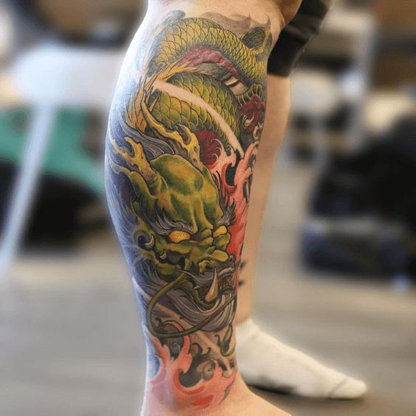 Green Classic Dragon Tattoo with Flames Tattoo on skin