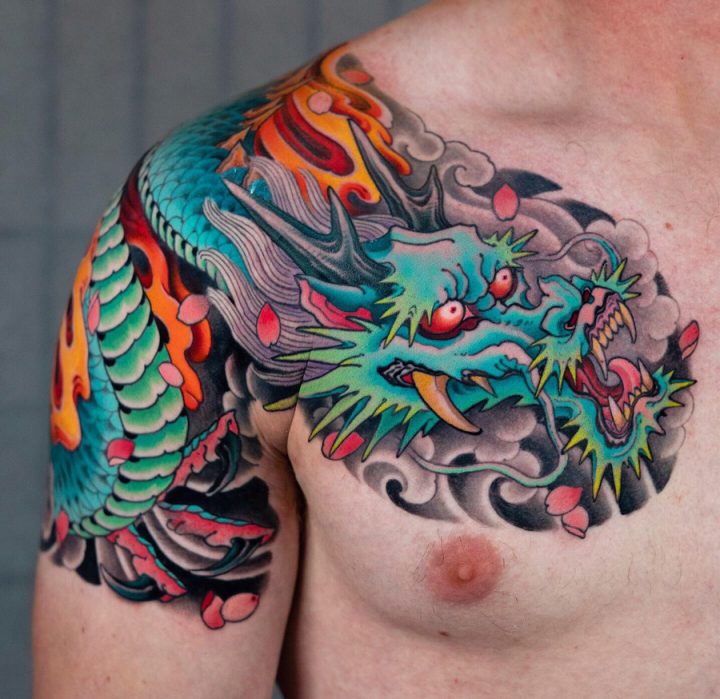 Vibrant Azure Dragon Chest and Shoulder Tattoo Tattoo on skin