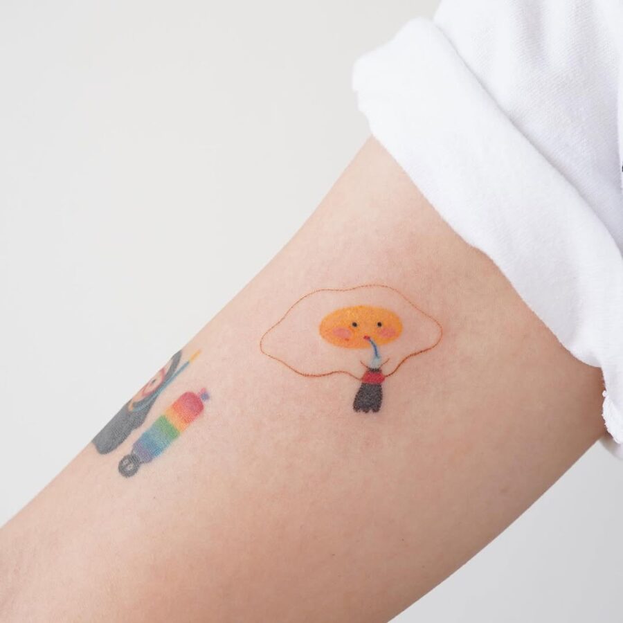 Charming cartoon egg character tattoo design Tattoo on skin