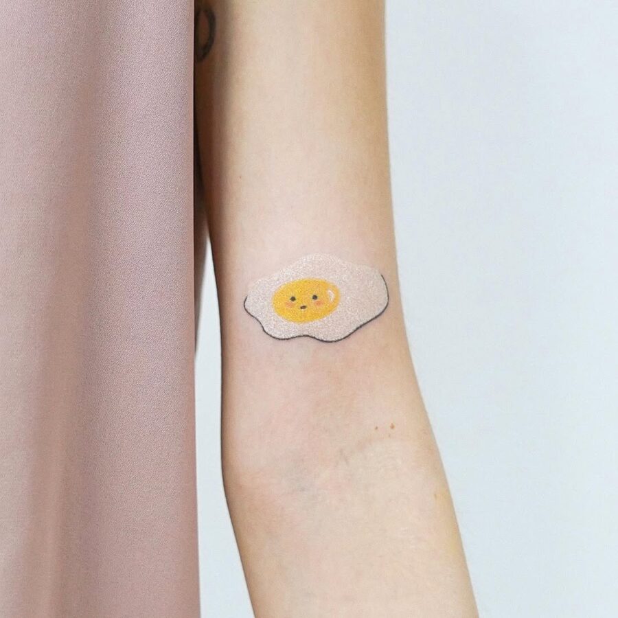 Charming minimalist egg tattoo for playful vibes Tattoo on skin