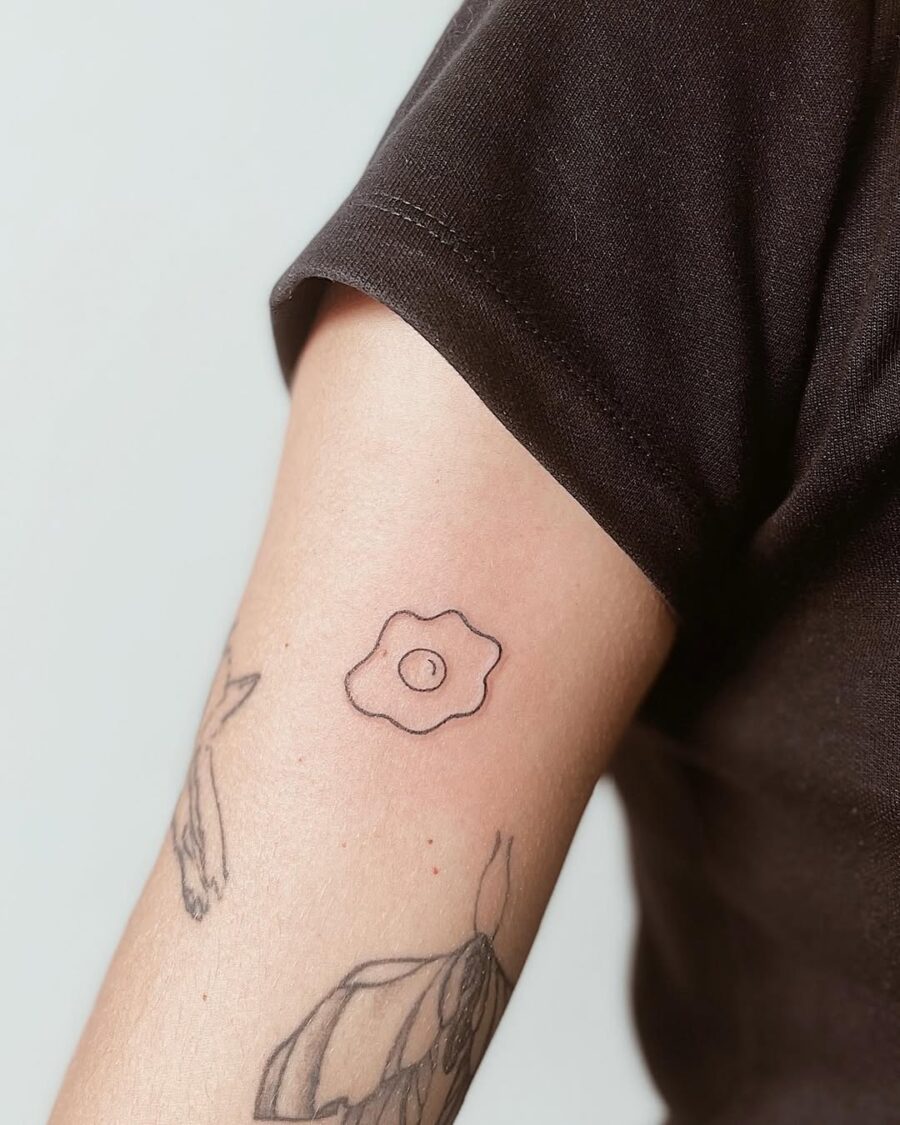 Charming Minimalist Egg Tattoo on Arm Tattoo on skin