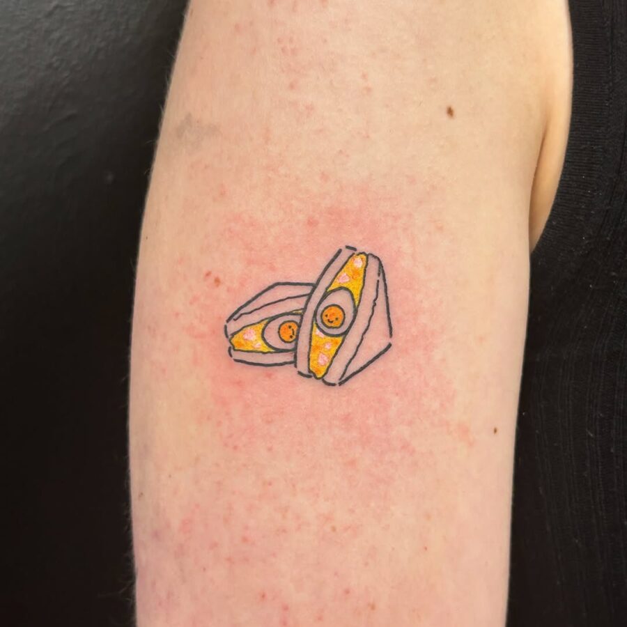 Creative egg tattoo with sunny-side up detail Tattoo on skin
