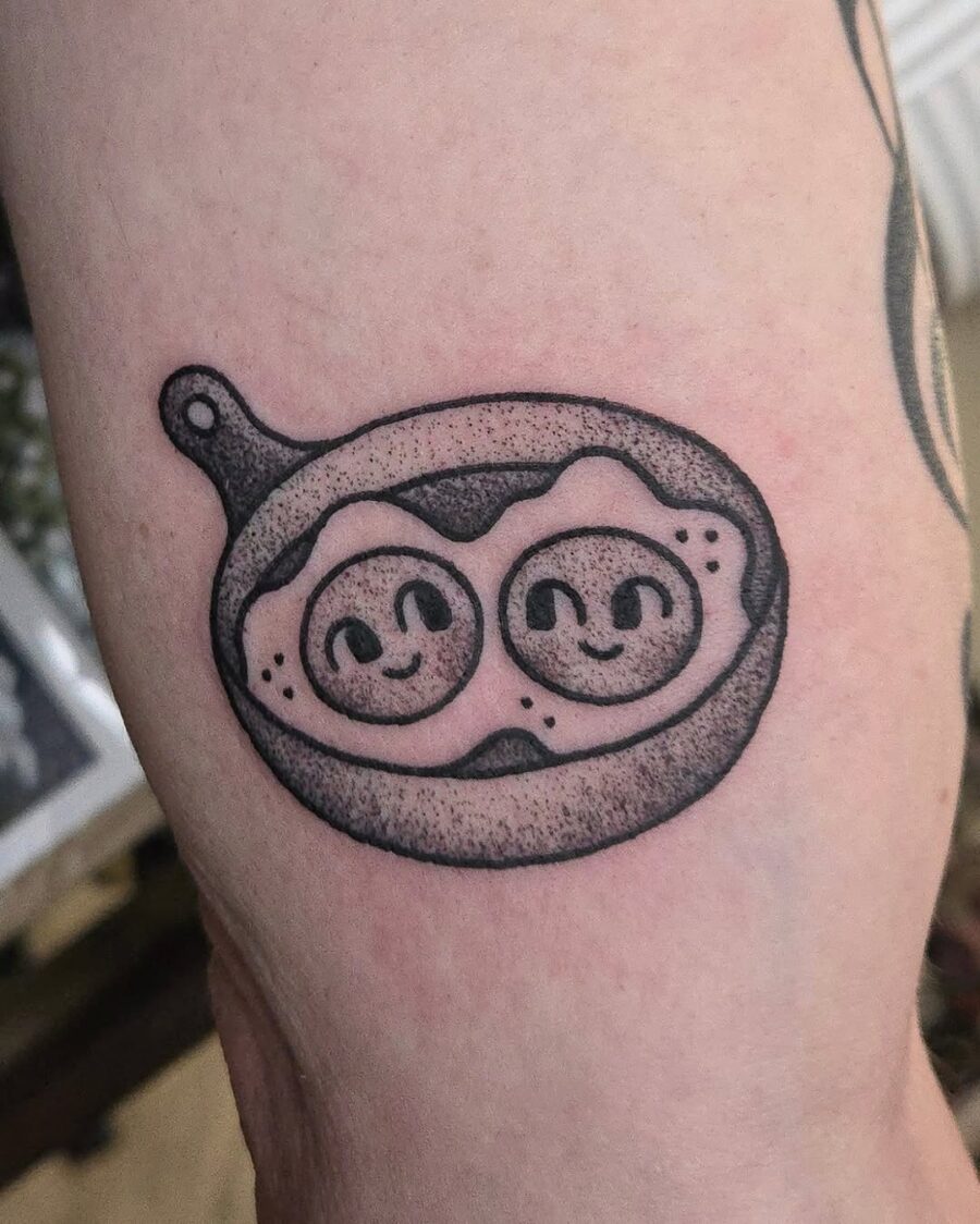 Cute egg tattoo with smiling faces Tattoo on skin