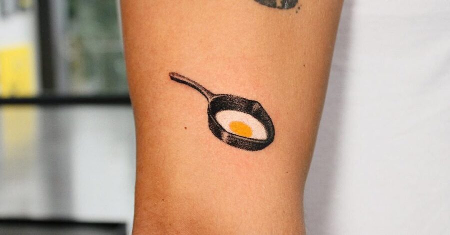 Minimalist Egg Tattoo in a Frying Pan Tattoo on skin