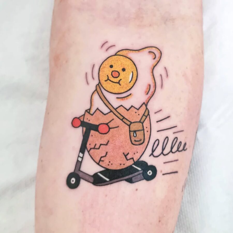 Playful egg tattoo on a scooter design Tattoo on skin