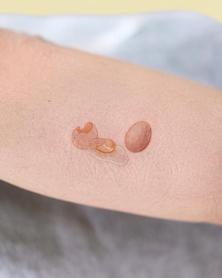 Realistic egg tattoo showcasing fresh elegance Tattoo on skin
