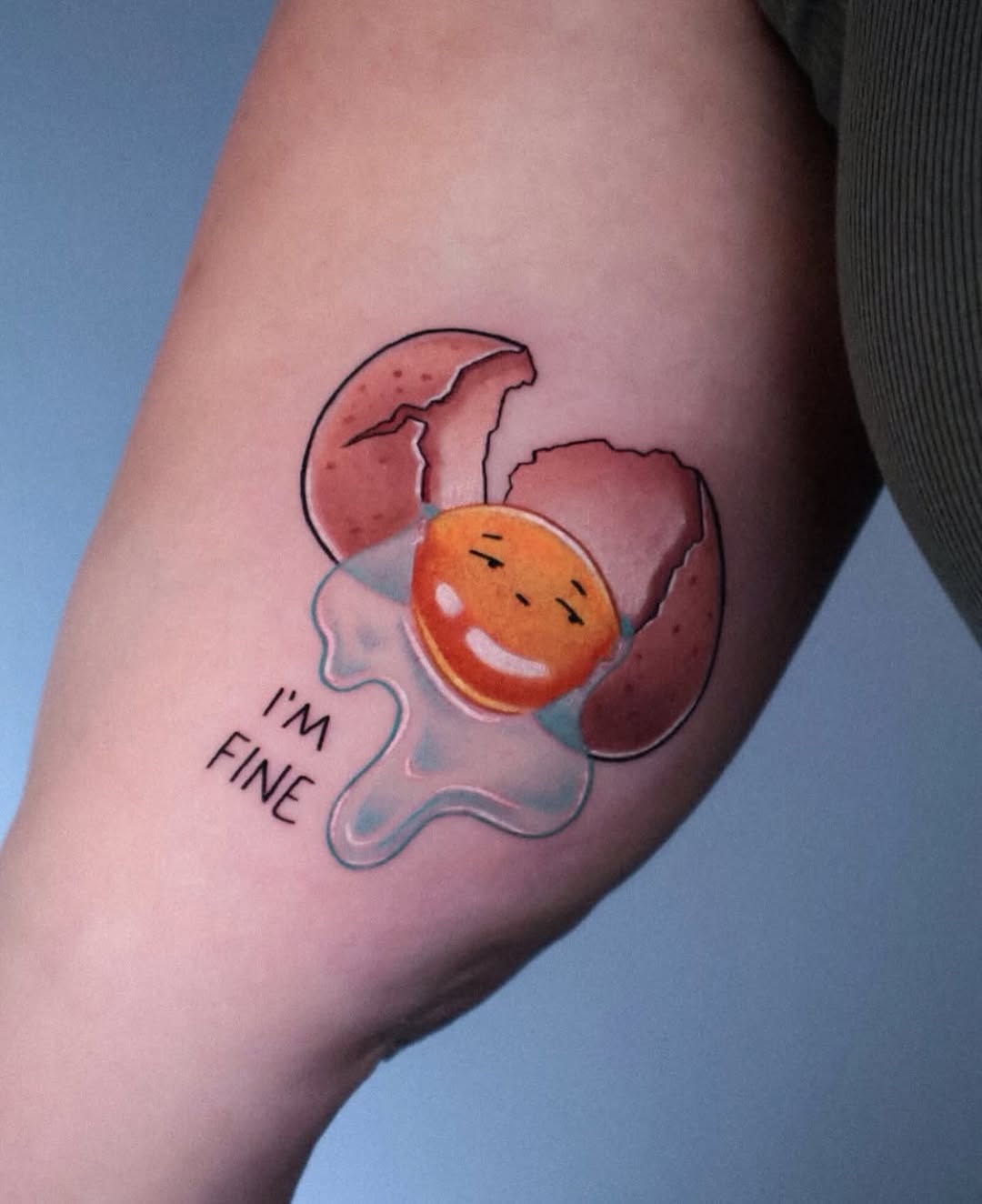 Whimsical egg tattoo with a cheerful vibe Tattoo on skin