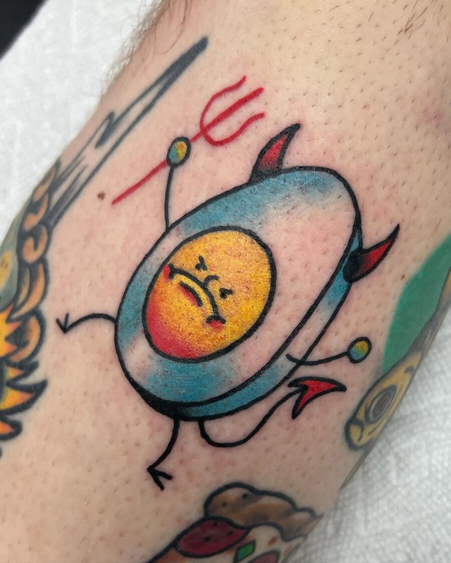 Whimsical egg tattoo with a devilish twist Tattoo on skin