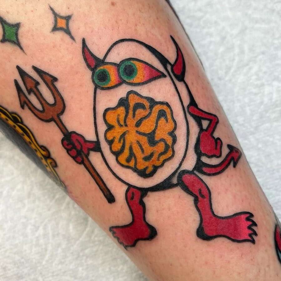 Whimsical egg tattoo with monster features Tattoo on skin