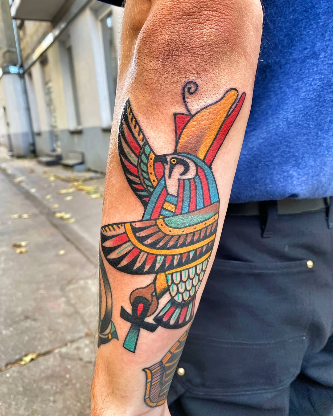 Colorful Egyptian-inspired tattoo of a bird Tattoo on skin