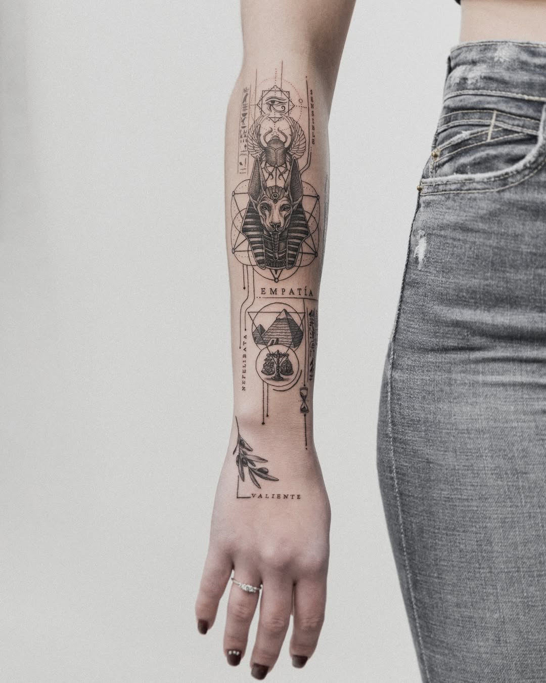 Intricate Egyptian-inspired tattoo on the forearm Tattoo on skin