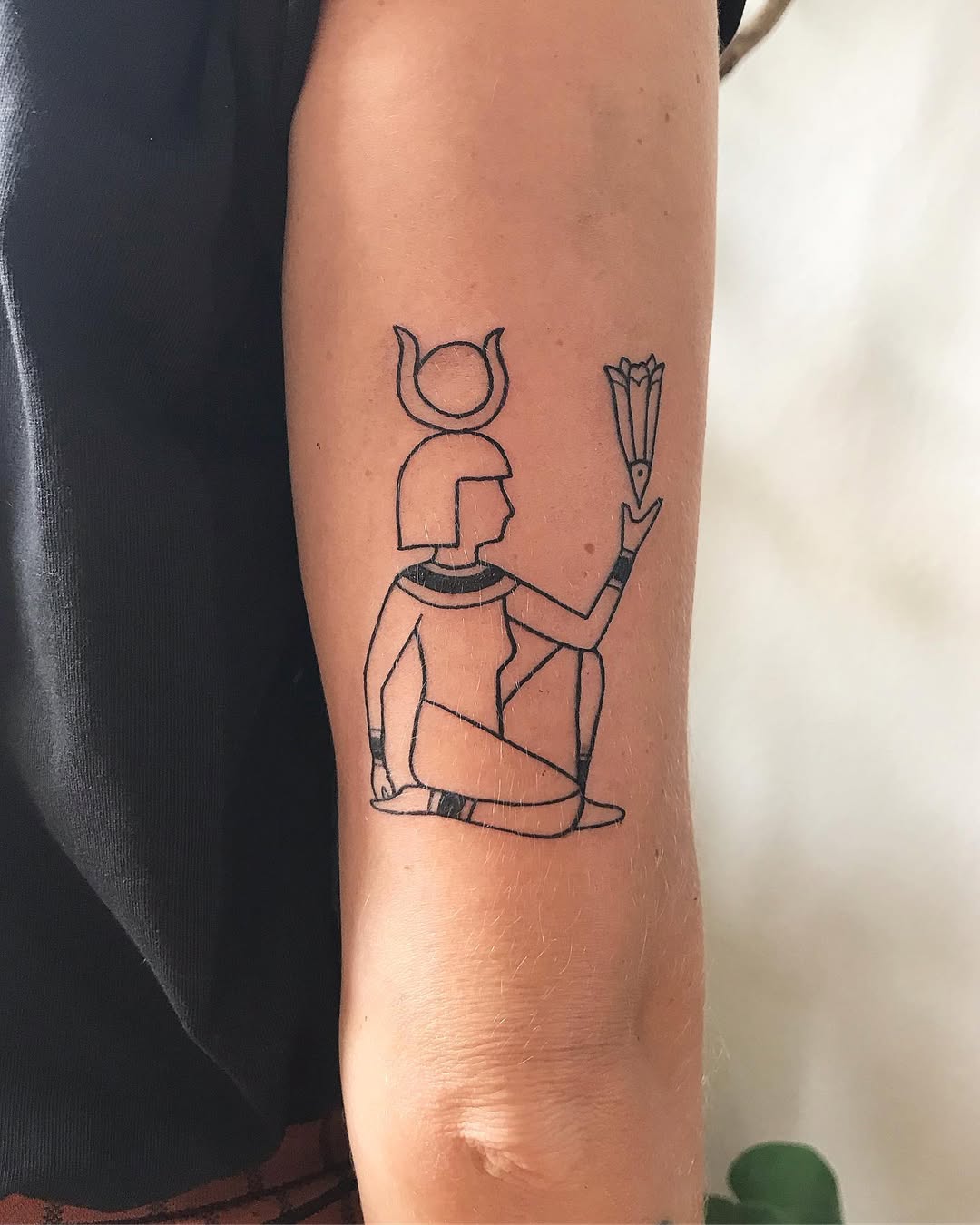 Stylish Egyptian goddess inked in minimalist design Tattoo on skin