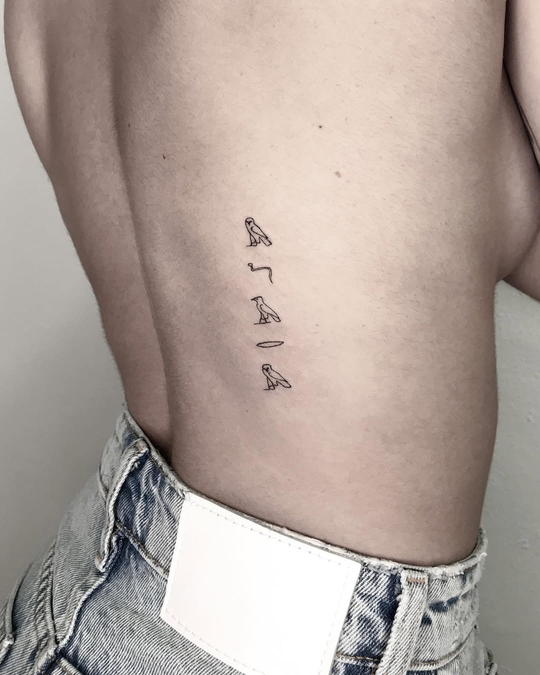 Unique minimalist Egyptian script tattoo design Tattoo on skin