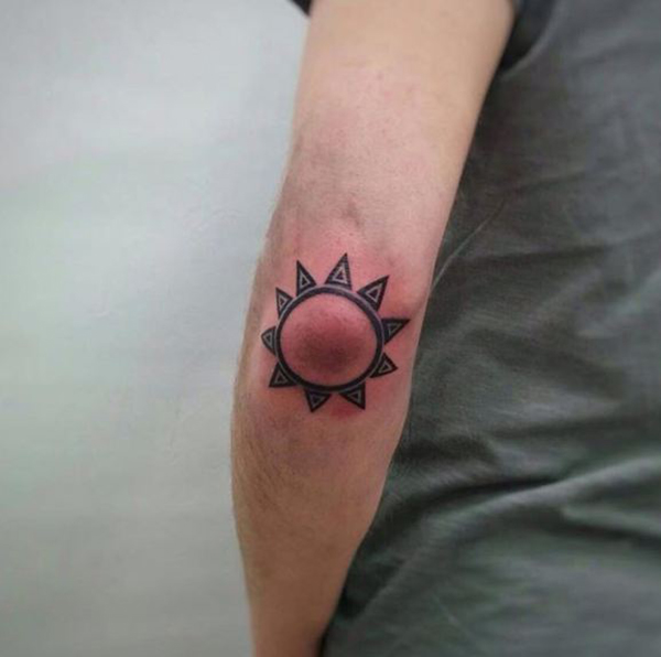Abstract Sun Surrounding Elbow Tattoo Tattoo on skin