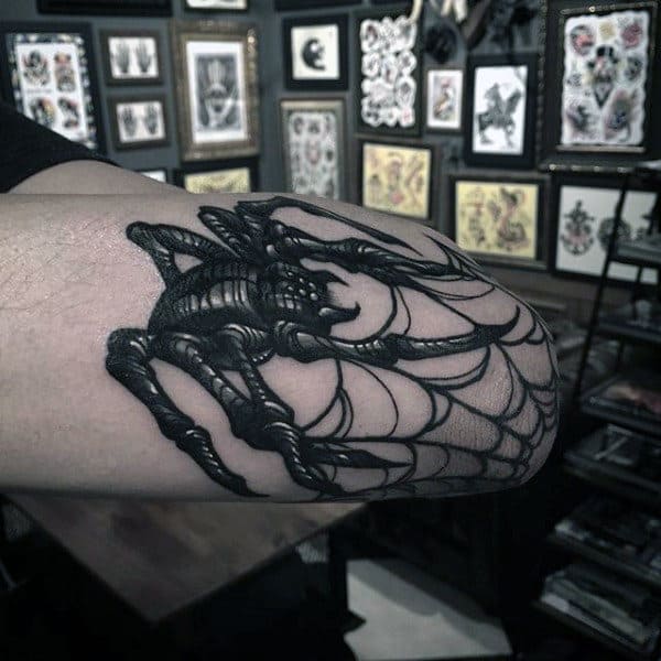 Detailed Spider Over a Web Elbow Tattoo Designs Tattoo on skin