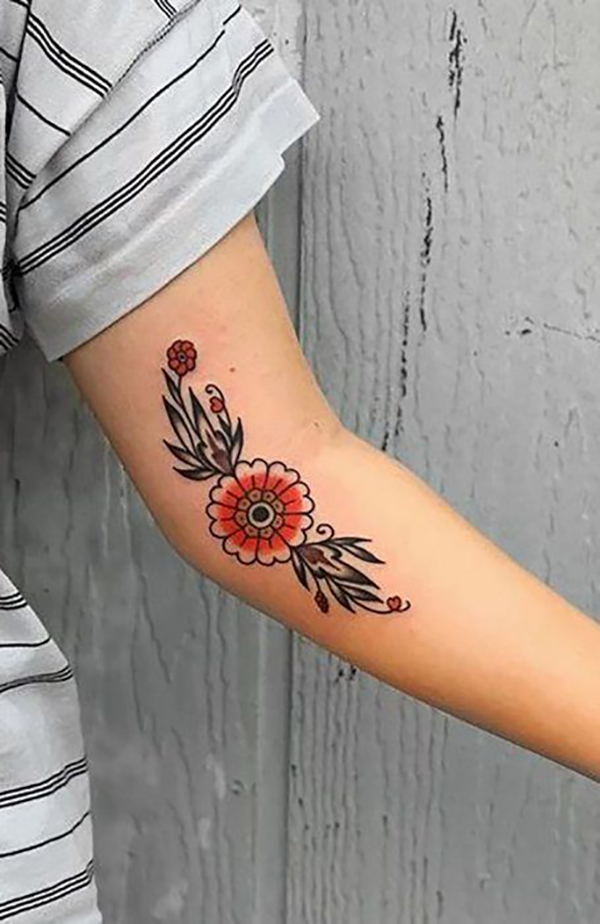 Stylized Orange Flower with Leaves Elbow Tattoo Tattoo on skin