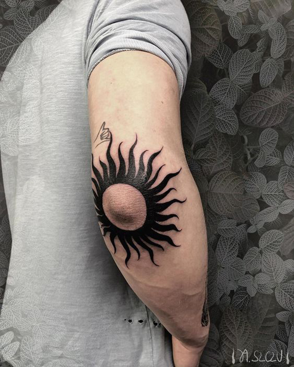 Sun with Curving Rays Around Elbow Tattoo Tattoo on skin