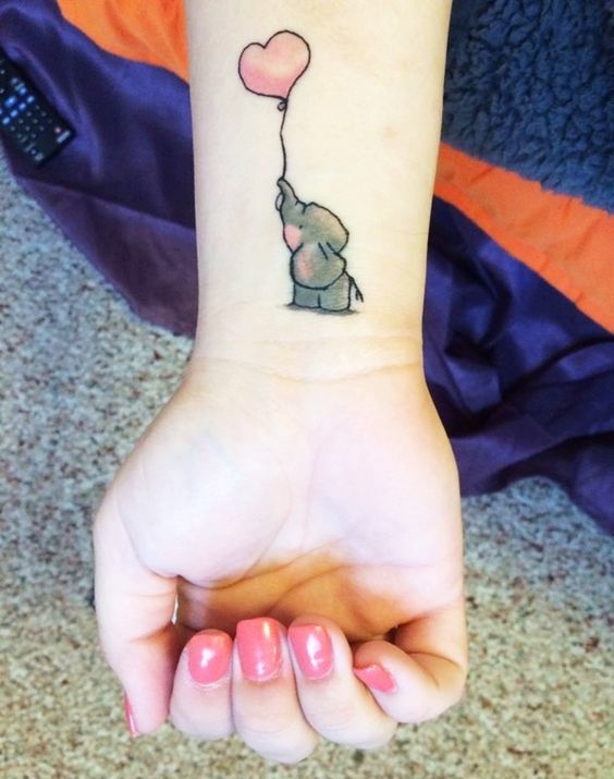 Baby Elephant Holding Pink Heart Balloon Wrist Tattoo Tattoo on skin