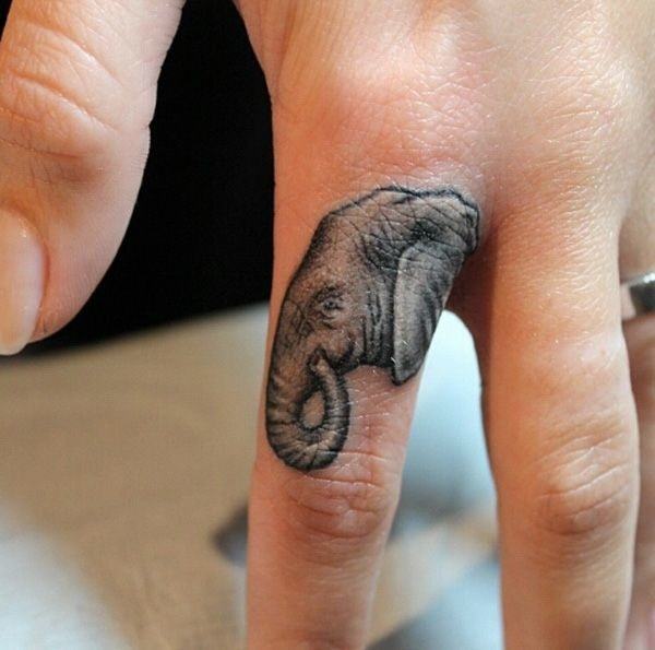 Realistic Micro Elephant Profile Middle Finger Tattoo Tattoo on skin