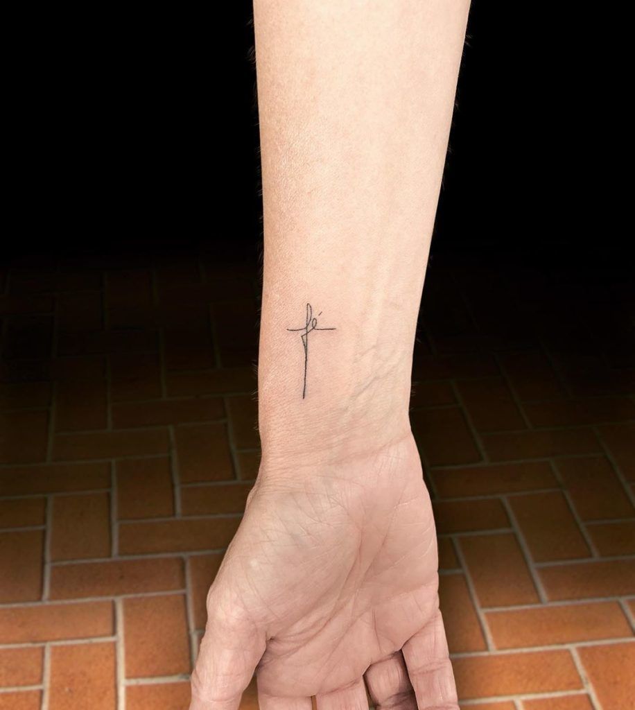 Dainty Line Cursive Cross Tattoo Tattoo on skin
