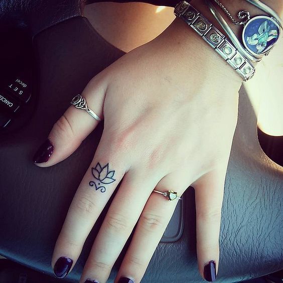 DELICATE LOTUS FINGER TATTOO IDEA ON A LADY Tattoo on skin