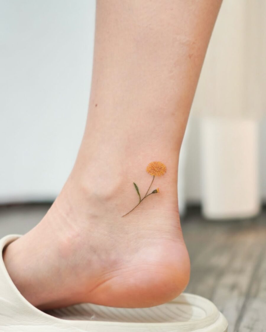 Charming yellow flower ankle tattoo for a sweet look Tattoo on skin