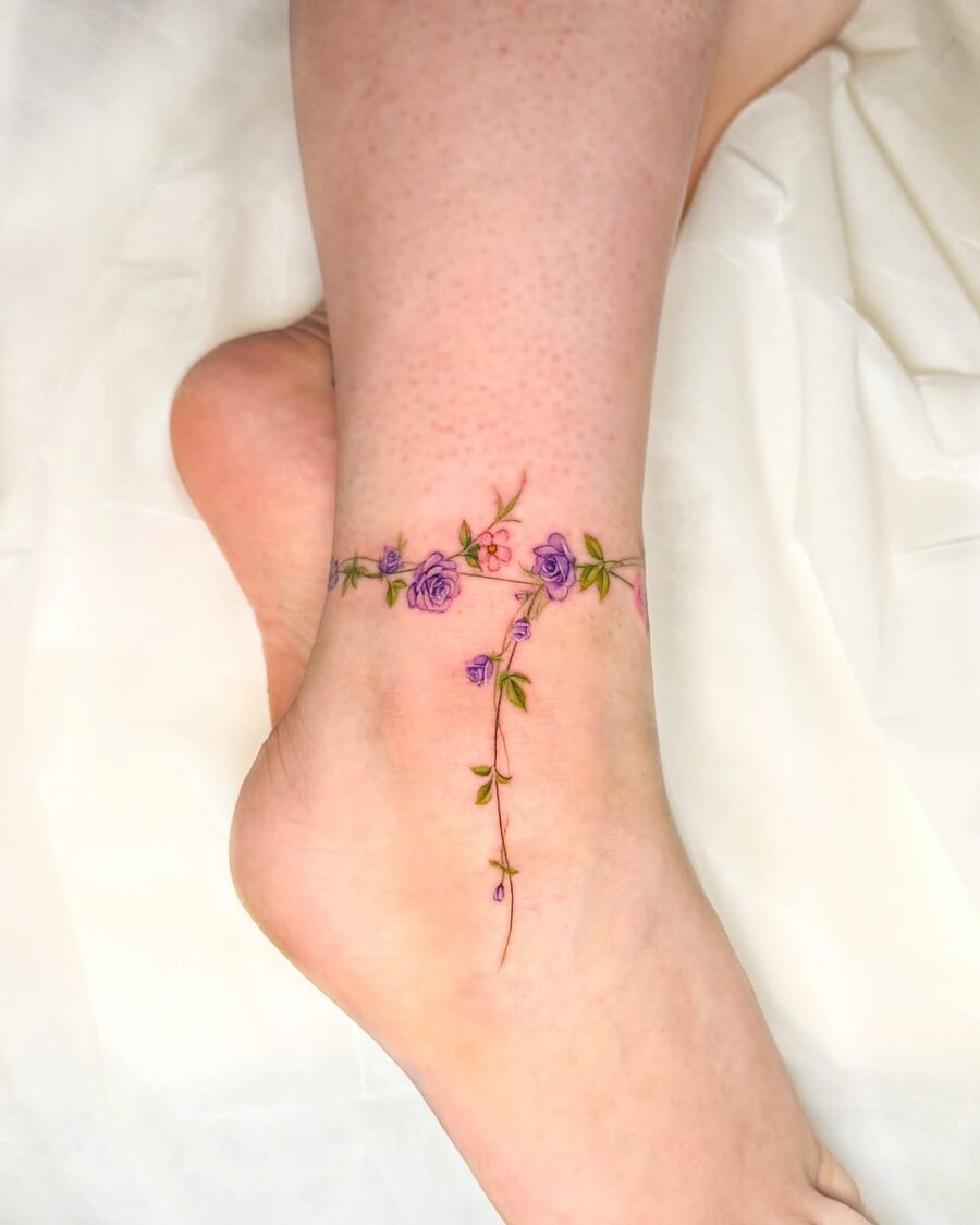 Dainty floral design wraps around the ankle Tattoo on skin