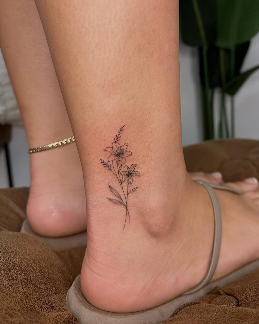 Delicate ankle tattoo with floral elements Tattoo on skin