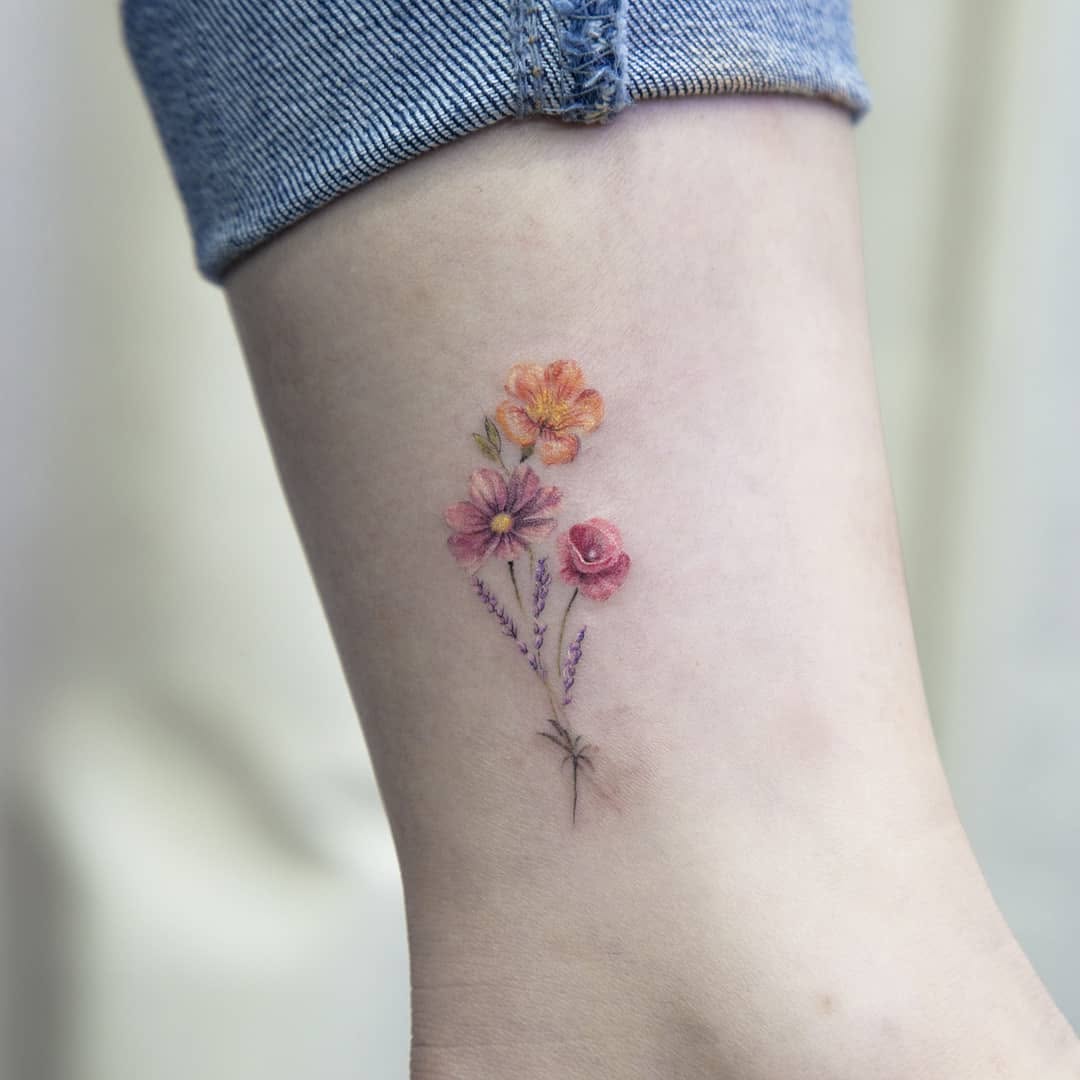 Delicate floral accents for ankle tattoos Tattoo on skin