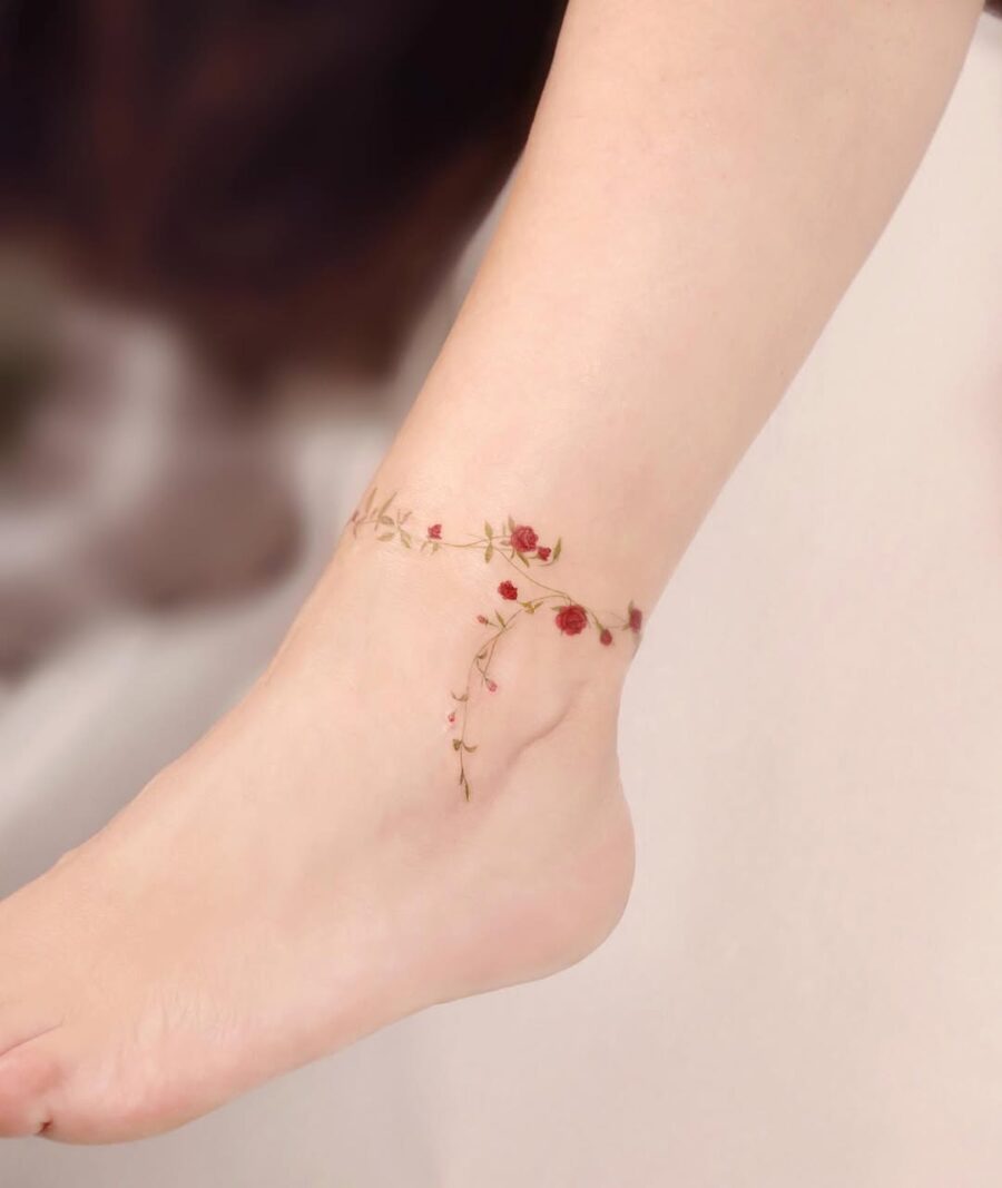 Delicate flower ankle tattoo with elegant roses Tattoo on skin