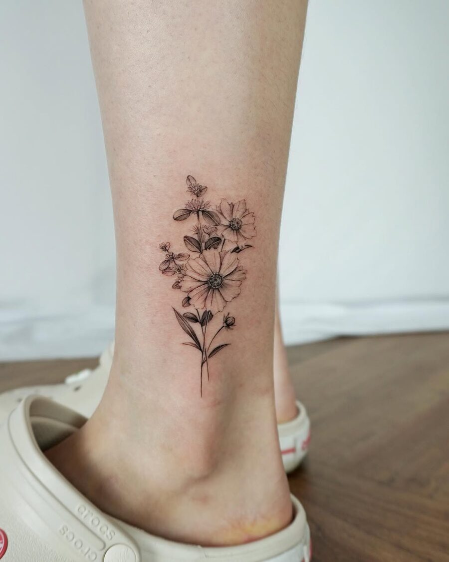 Delicate flowers surrounded by buzzing bees Tattoo on skin