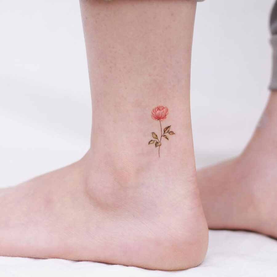 Delicate pink rose ankle tattoo in bloom Tattoo on skin