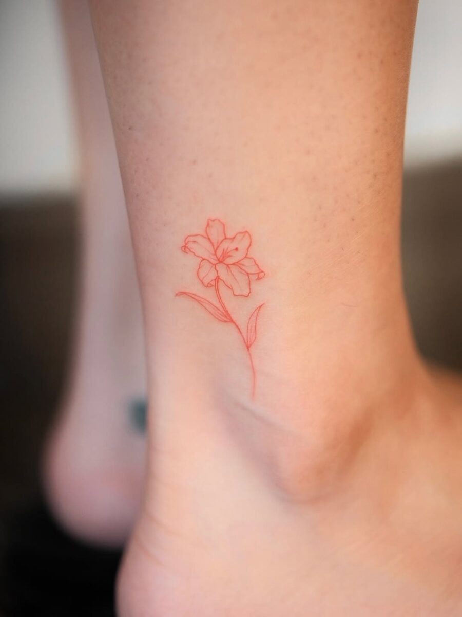 Delicate red flower ankle tattoo concept Tattoo on skin