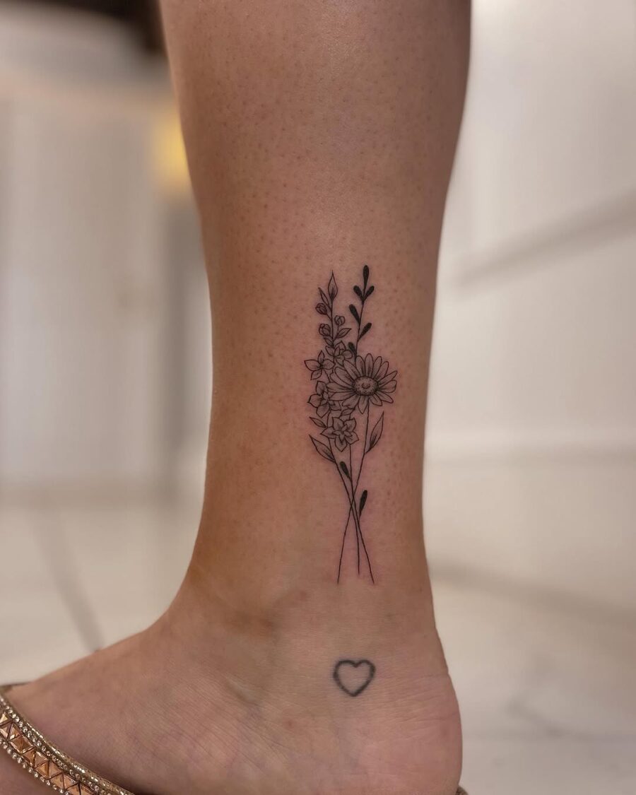 Elegant floral ankle tattoo with delicate details Tattoo on skin