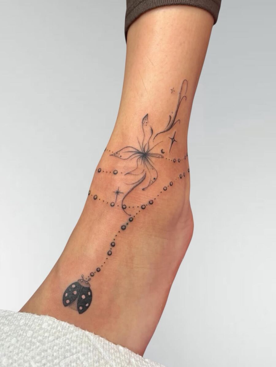 Elegant flower tattoo with whimsical accents flower ankle tattoos