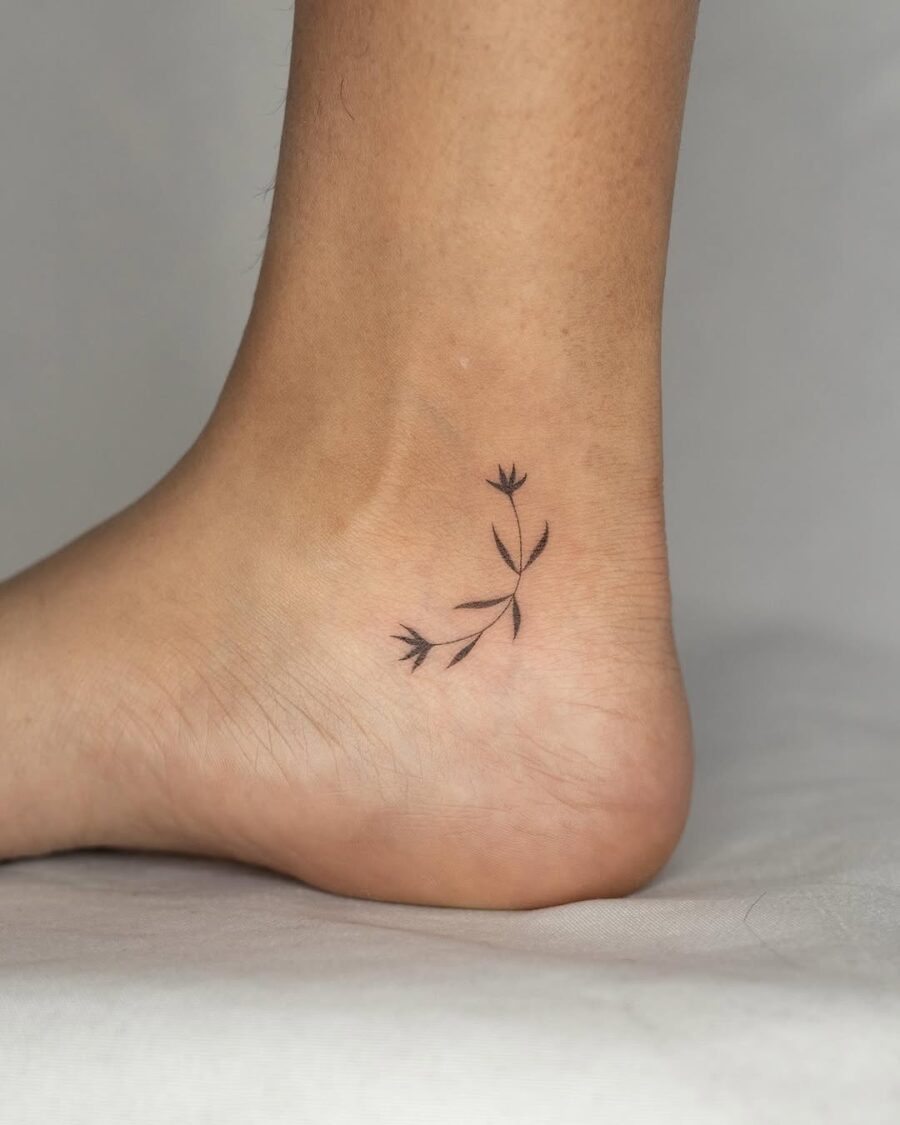Minimalistic flower ankle tattoo with elegant curves Tattoo on skin