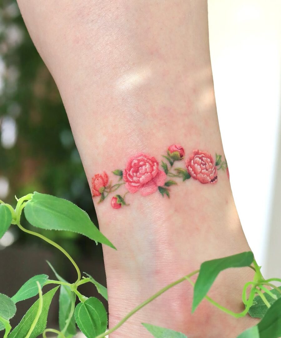 Stunning pink floral design around the ankle Tattoo on skin