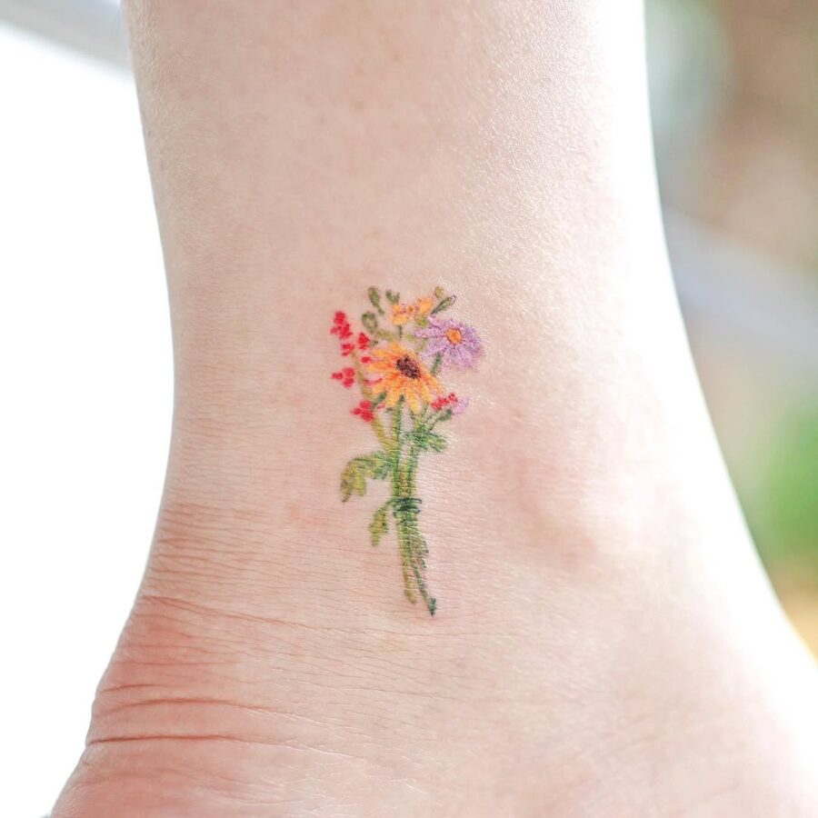 Vibrant floral ankle tattoo for nature lovers Tattoo on skin