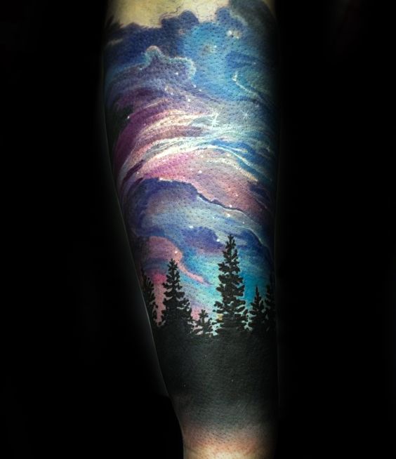 Northern Lights over a Polar Forest forearm tattoo Tattoo on skin