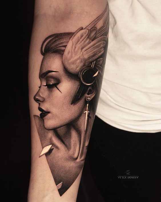 Profile of Woman with Sword Earring forearm tattoo Tattoo on skin