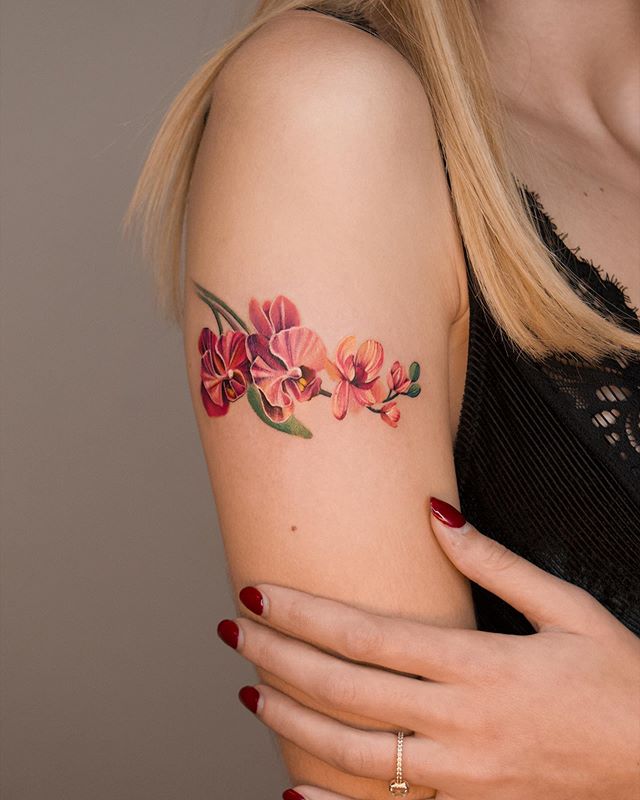 Precious Orchids on Upper Arm Tattoo Designs Tattoo on skin
