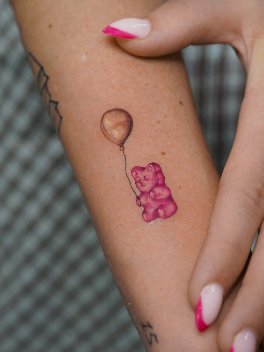 Charming Gummy Bear Tattoo Holding Balloon Tattoo on skin