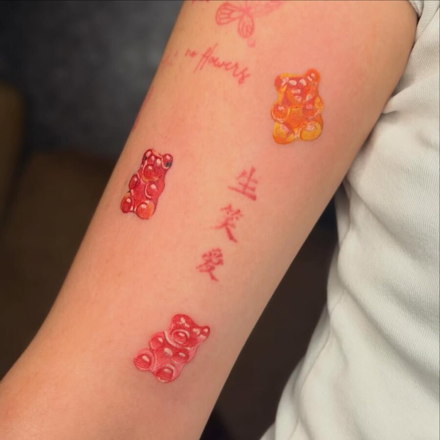 Colorful gummy bear tattoos on a playful arm Tattoo on skin