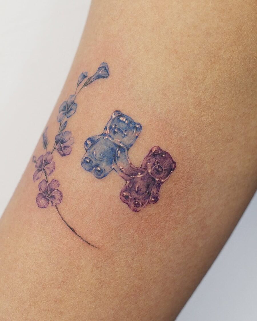 Colorful gummy bears with floral accents tattoo Tattoo on skin