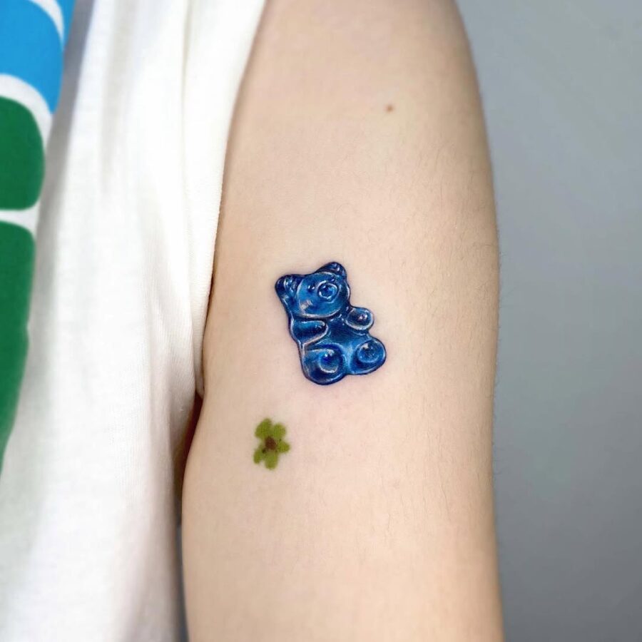 Cute blue gummy bear tattoo on arm Tattoo on skin