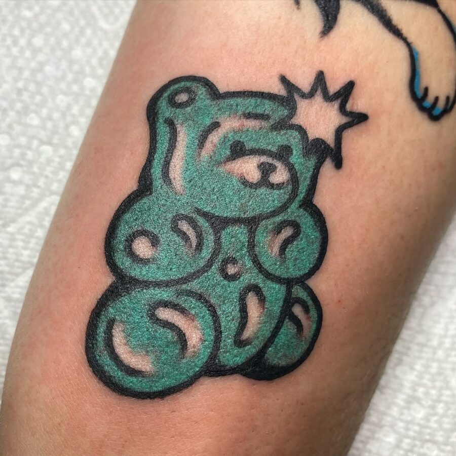 Whimsical green gummy bear tattoo design Tattoo on skin