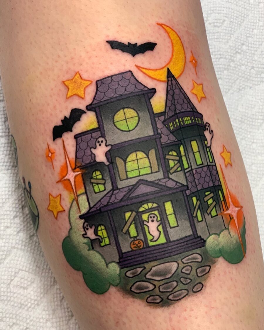 Charming haunted house tattoo with playful ghosts Tattoo on skin